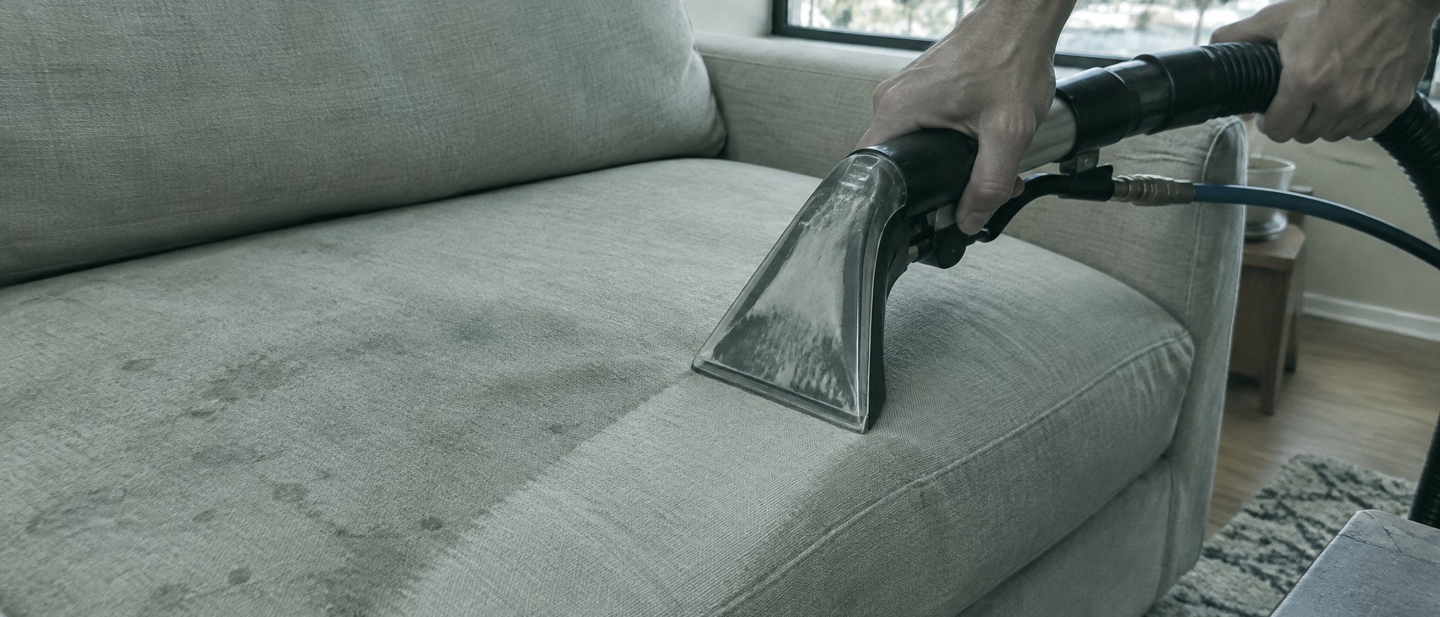 extraction wand on a sofa cushion